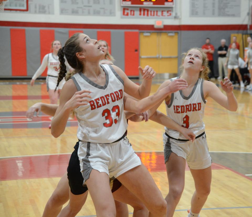 Victoria Gray (left) and Grace Fulop of Bedford battle for a rebound during a 56-37 win over Dexter Friday night.