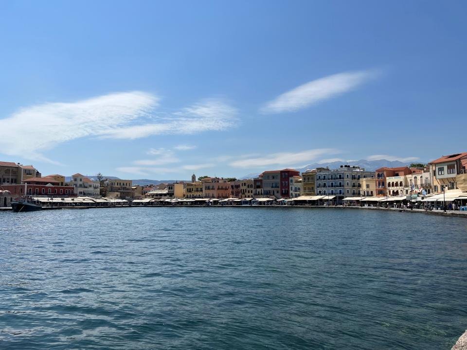 view of a mediterranean coastline town from the water on a clear day