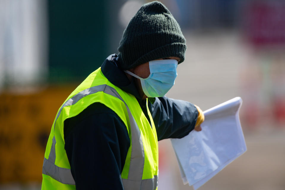 A steward directs cars as coronavirus testing continues at Edgbaston Cricket Ground, Birmingham, as the UK continues in lockdown to help curb the spread of the coronavirus.