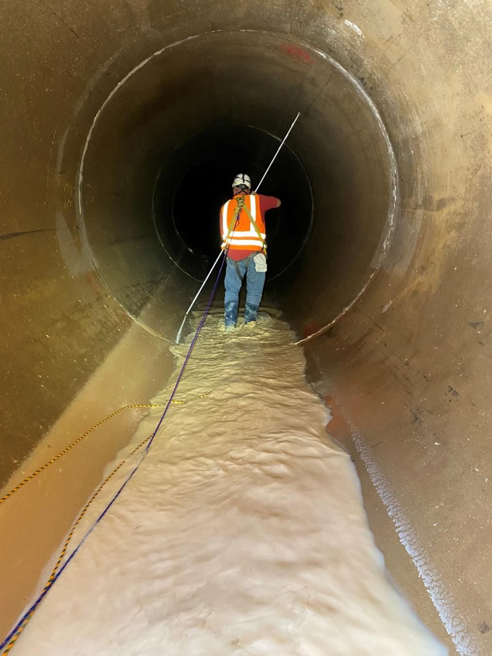 A member of the Engineering Inspection team at work in the 120-inch pipe.