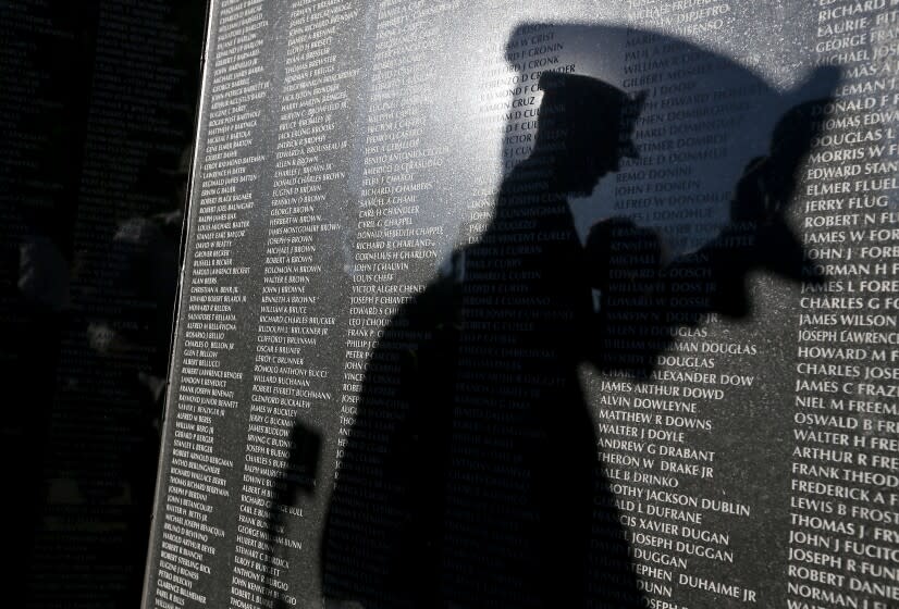 FULLERTON, CALIF. - NOV. 11, 2021. The shadow of Army Brig. Gen. Robert Wooldridge falls on a Korean War memorial that was unveiled at Hillcrest Park in Fullerton on Veterans Day, Thursday, Nov. 11, 2021. The new memorial features five large marble stars inscribed with the names of more than 36,000 combatants who died in what has become known as "The Forgotten War." (Luis Sinco / Los Angeles Times)