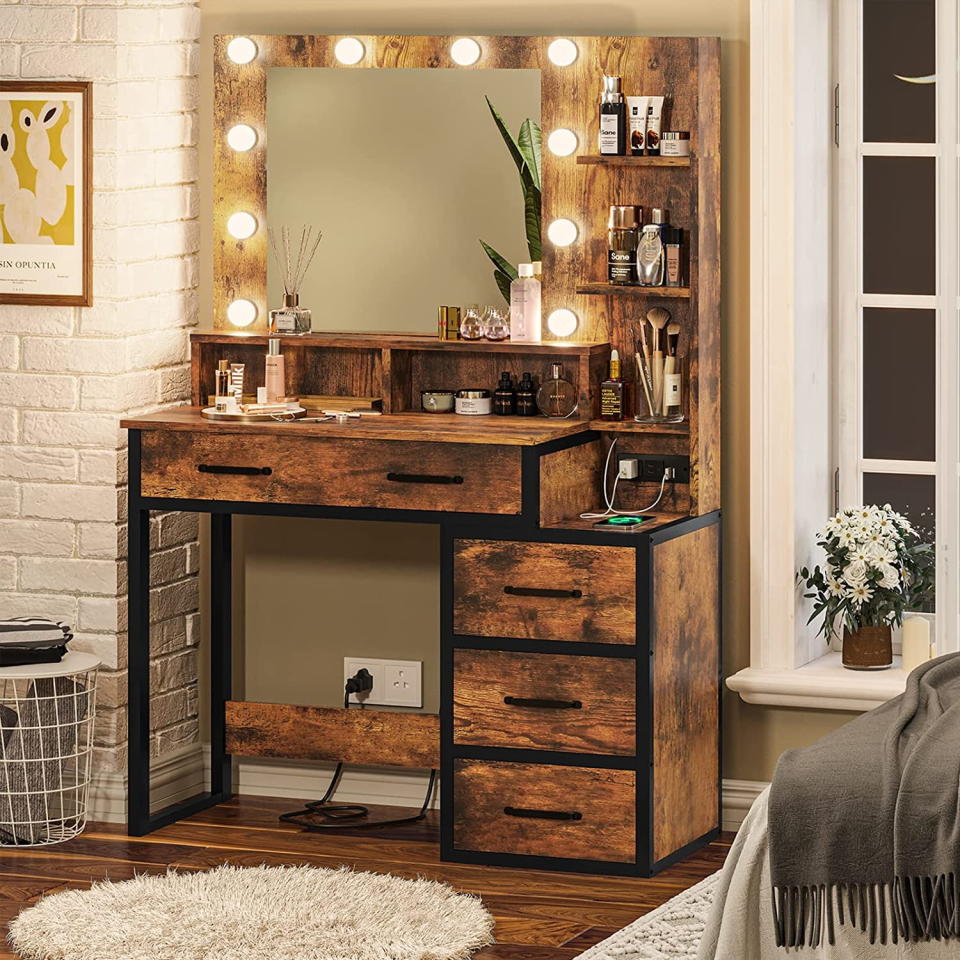 <p><a href="https://clicks.trx-hub.com/xid/hearstcorp_9eb67_clg?q=https%3A%2F%2Fwww.walmart.com%2Fip%2FRustic-Vanity-Desk-Makeup-Dresser-Desk-Table-with-Lighted-Mirror-Charging-Station-5-Drawers-10-LED-Light-Brown-Black%2F463439398&p=https%3A%2F%2Fwww.countryliving.com%2Fhome-design%2Fdecorating-ideas%2Fg44785354%2Fbest-makeup-vanity%2F&utmSource=yahoo-us&utmCampaign=55&utmMedium=syn" rel="nofollow noopener" target="_blank" data-ylk="slk:Shop Now;elm:context_link;itc:0;sec:content-canvas" class="link ">Shop Now</a></p><p>Rustic Vanity </p><p>walmart.com</p><p>$179.77</p>