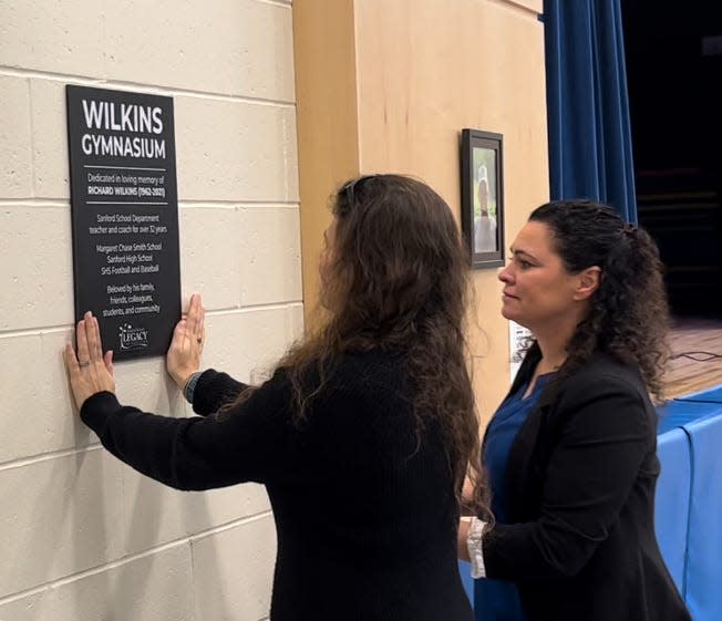 Richard Wilkins' wife Christine and daughter Autumn attended Saturday's dedication ceremony along with Rich's twin brother, Robert, and officially raised the new plaque next to the stage within the new Richard Wilkins Gymnasium at the Margaret Chase Smith Elementary School in Sanford.