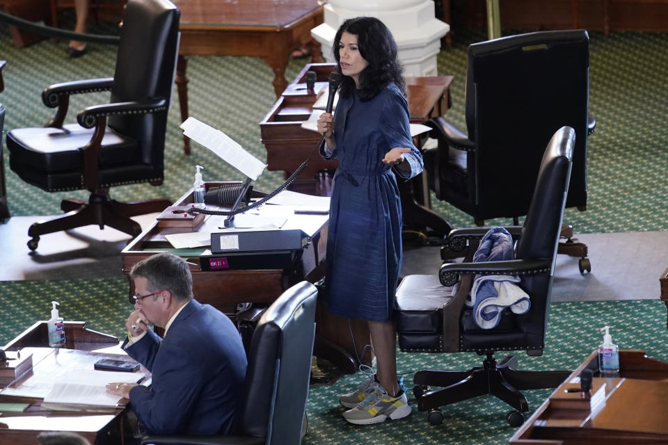 Texas State Sen. Carol Alvarado, D-Houston, wears running shoes as she filibusters Senate Bill 1, a voting bill, at the Texas Capitol Wednesday, Aug. 11, 2021, in Austin, Texas. (AP Photo/Eric Gay)