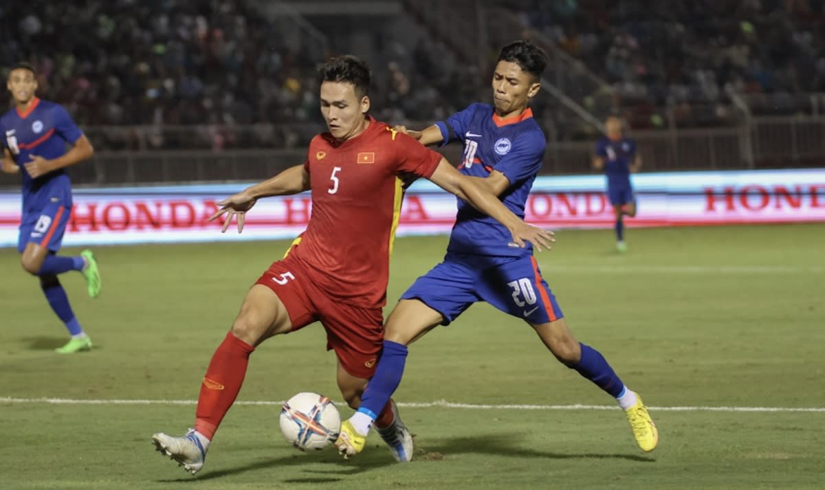 Singapore's Hazzuwan Halim (right) tussles with a Vietnamese player during their international friendly in Ho Chi Minh City. (PHOTO: FAS)