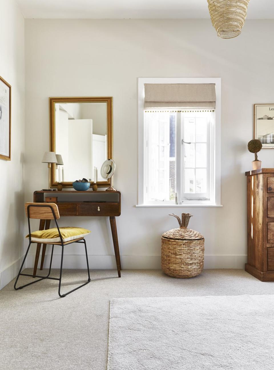 a room with a dressing table and a chair