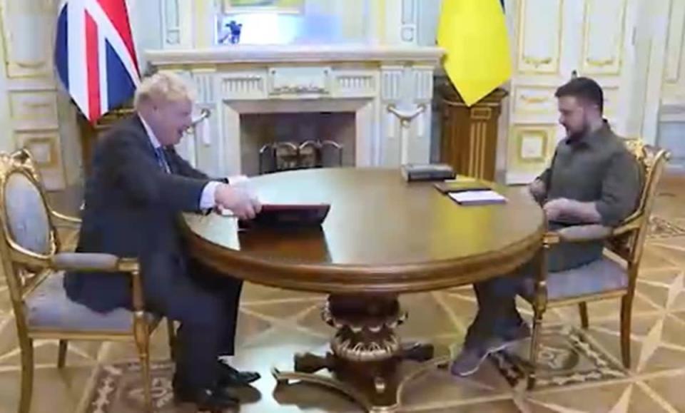 The Prime Minister and Ukrainian president sat down for talks after Mr Johnson gave his host a biography of the Queen seen next to him (Ukrainian Presidential Press Office/PA) (PA Media)
