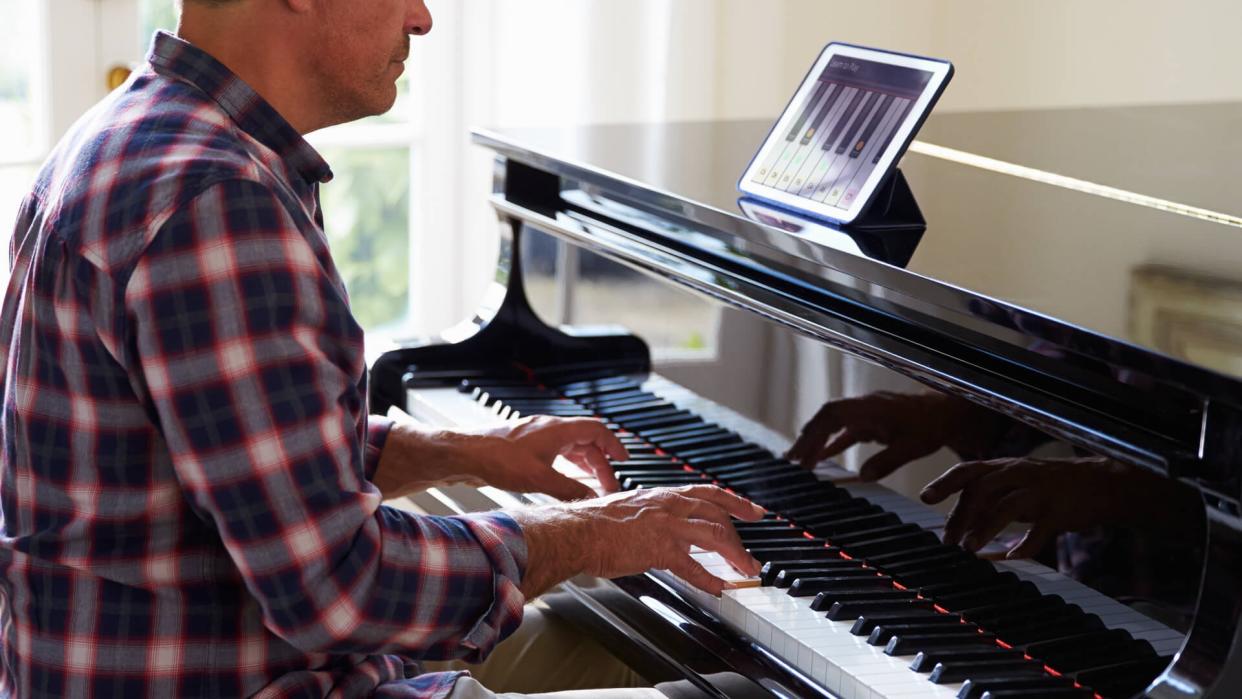 man playing the piano at home