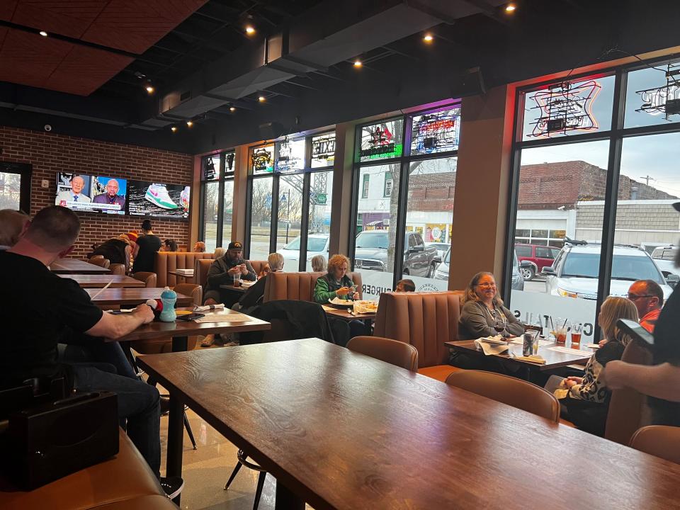 Customers sit in booths with large windows overlooking Fifth Street in Valley Junction at Bix & Co.