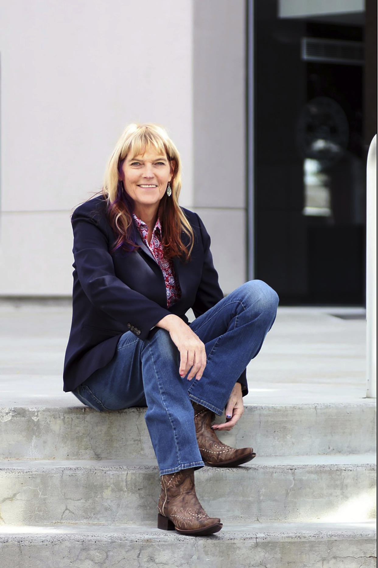 This photo provided by the Kimi Cole Campaign Kimi Cole has her photo taken in front of the state Legislature on Wednesday, Nov. 10, 2021 in Carson City, Nev. Cole wants to become the country's first openly transgender politician elected to a statewide office. The Nevada Democrat announced plans to run for lieutenant governor on Wednesday. (Kimi Cole Campaign via AP)