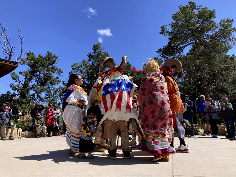 The Guardians of the Grand Canyon, a Havasupai traditional dance group, performs at the South Rim of Grand Canyon National Park, Ariz., on Thursday, May 4, 2023. The Havasupai Tribe and the park held a public ceremony to mark the renaming of a popular campground from Indian Garden to Havasupai Gardens. (AP Photo/Felicia Fonseca)