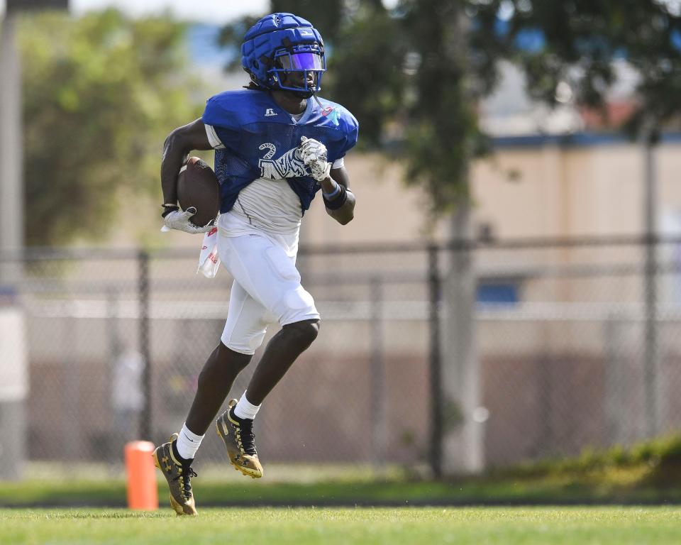 Martin County's Antwan Mitchell carries in a game of football scrimmage, Friday, May, 12, 2023, in Stuart.
