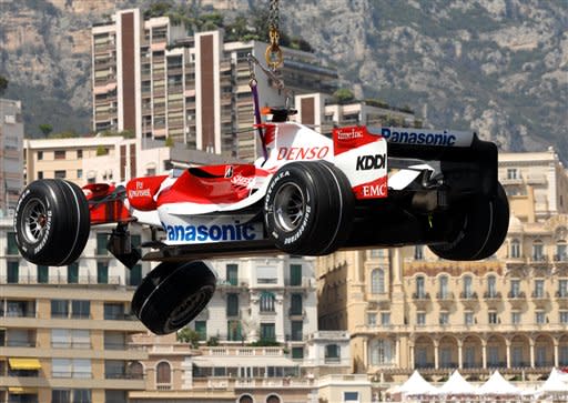 The wreck of German formula one driver Ralf Schumacher's Toyota is lifted up in front of the buildings of Monaco Thursday May 24, 2007. Schumacher crashed during the second free practice session for Sunday's Monaco Grand Prix. (AP Photo/ Claude Paris)