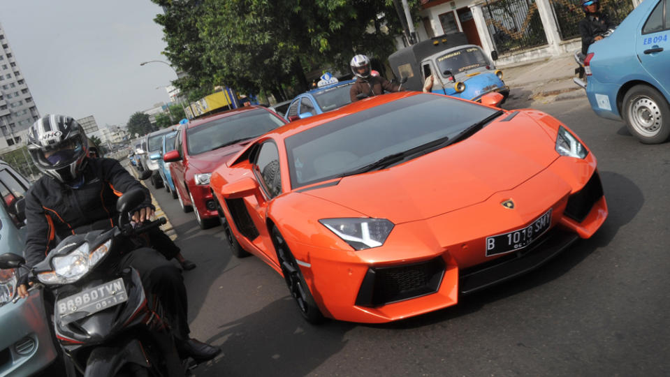 A Lamborghini supercar in trafic.