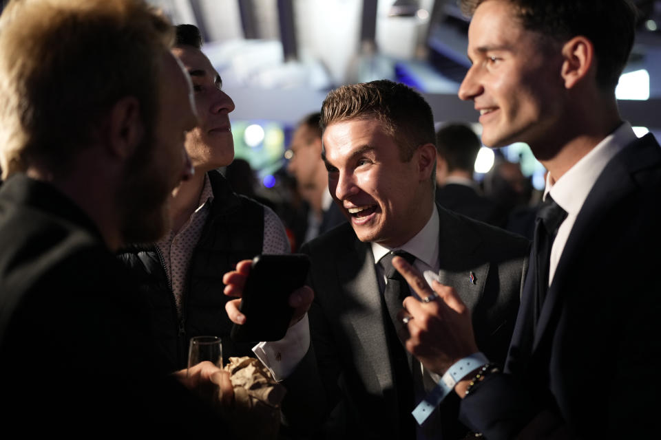 Supporters of French far-right National Rally react at the party election night headquarters after French President Emanuel Macron announced he dissolves National Assembly and calls new legislative election after defeat in EU vote, Sunday, June 9, 2024 in Paris. First projected results from France put far-right National Rally party well ahead in EU elections, according to French opinion poll institutes. (AP Photo/Lewis Joly)