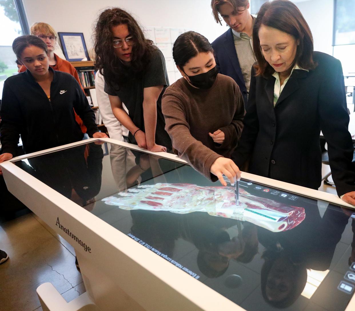 Sports medicine teaching assistant Cassidy Cortez, center, shows U.S. Sen. Maria Cantwell, right, the different views of anatomy available on the Anatomage Table during class at Olympic High School on Tuesday.