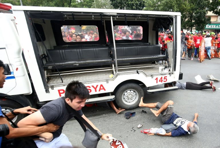 At an anti-US rally, a police van reversed quickly into dozens of people then forward again, running over at least two protesters