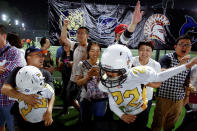 <p>Eagles players celebrate their win over the Sharklets in their Future League American football youth league match in Beijing, May 26, 2017. (Photo: Thomas Peter/Reuters) </p>