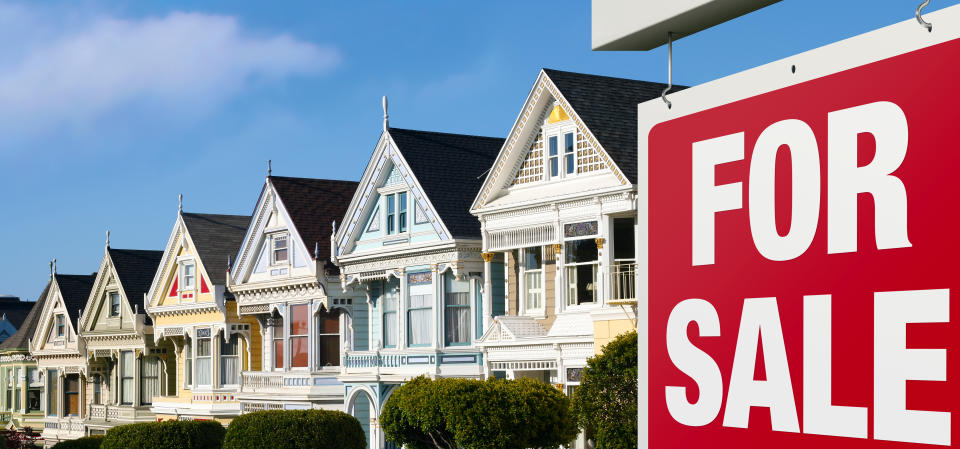 Dreaming of buying one of those colorful iconic San Francisco row houses. For Sale sign is visible in front.