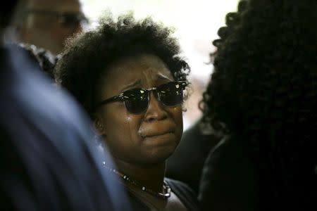 A family member weeps while entering the W.O.R.D. Ministries Christian Center for the funeral of Walter Scott, Saturday, April 11, 2015, in Summerville. Scott was killed by a North Charleston police officer on Saturday, April 4, 2015. REUTERS/David Goldman/Pool