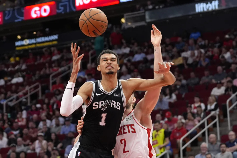 San Antonio Spurs' Victor Wembanyama (1) is fouled by Houston Rockets' Jock Landale (2) while reaching for a rebound during the first half of an NBA basketball game Tuesday, March 5, 2024, in Houston. (AP Photo/David J. Phillip)