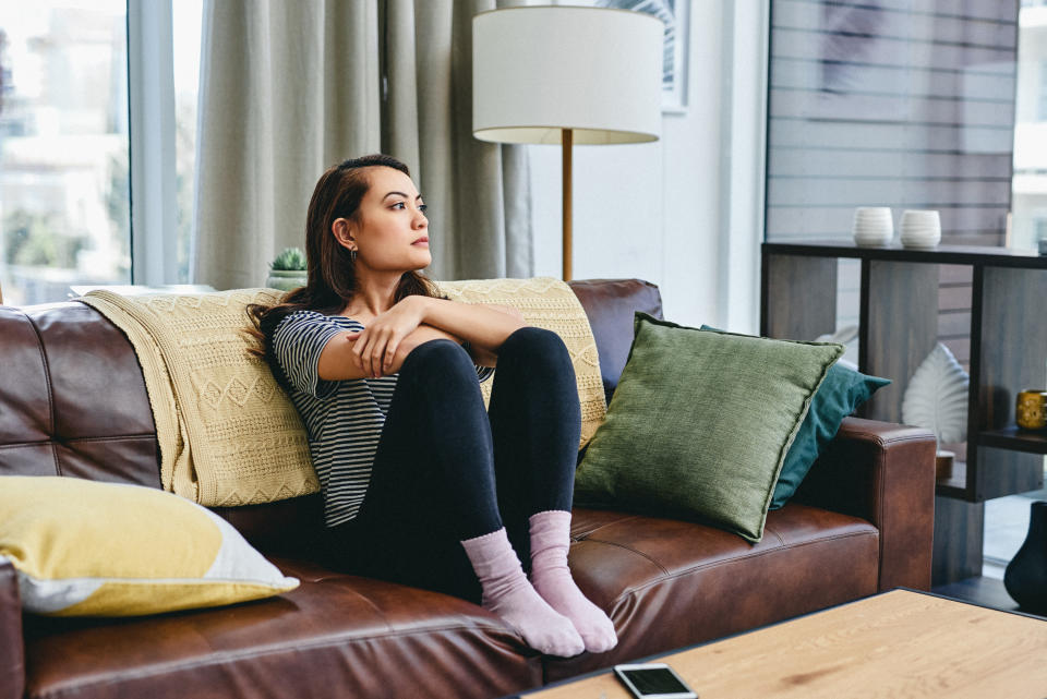 A woman thinking on her couch