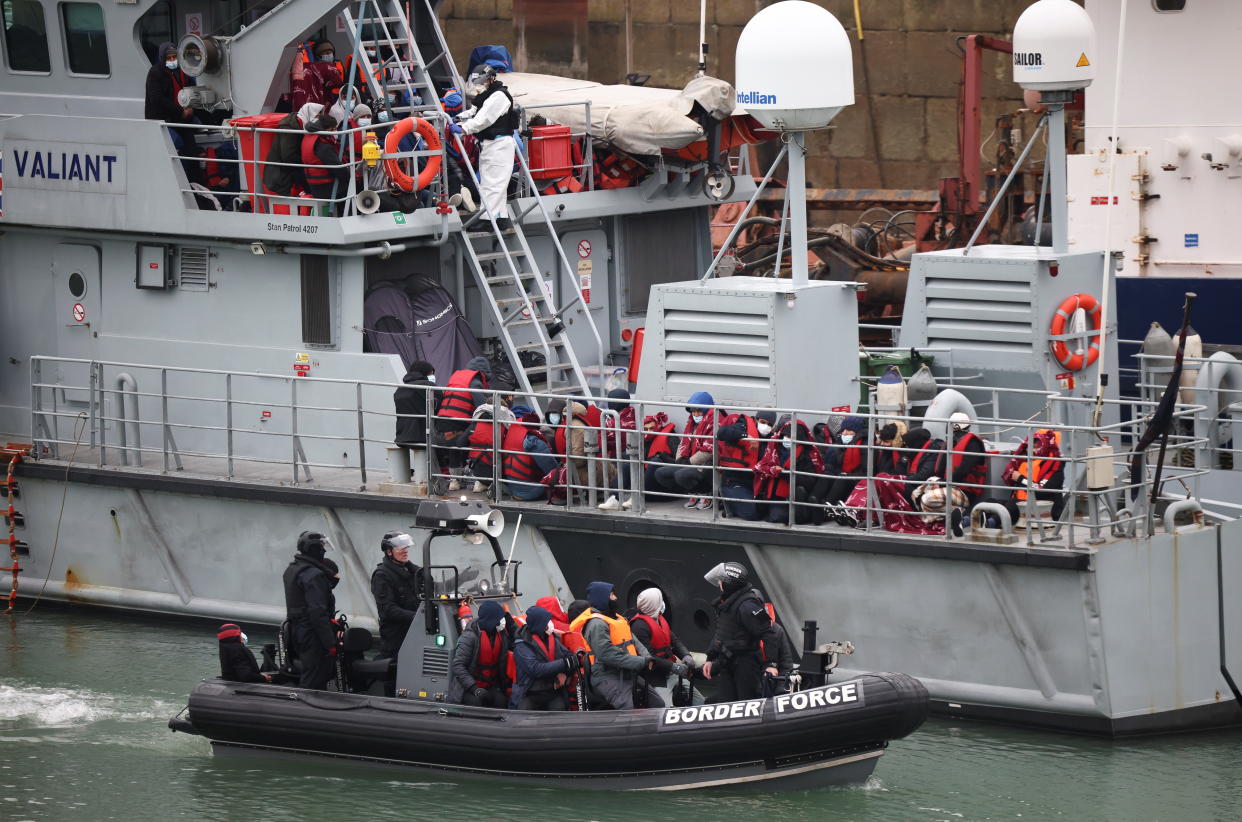 Migrants onboard a Border Force rescue boat wait to disembark at Dover harbour, after having crossed the channel, in Dover, Britain, November 24, 2021. REUTERS/Henry Nicholls