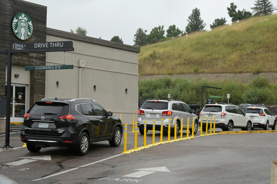 4 cars waiting in a Starbucks drive thru line