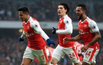 <p>Alexis Sanchez leads the celebrations after putting Arsenal in front</p>