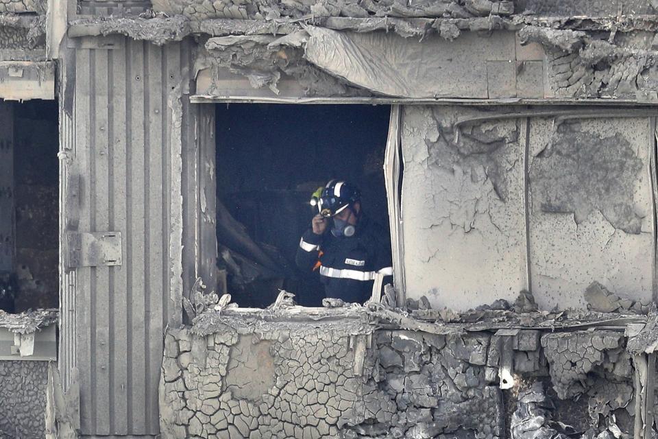 <p>A firefighter conducts a search of burned out flat in Grenfell Tower on June 15, 2017 in London, England. (Photo: Dan Kitwood/Getty Images) </p>