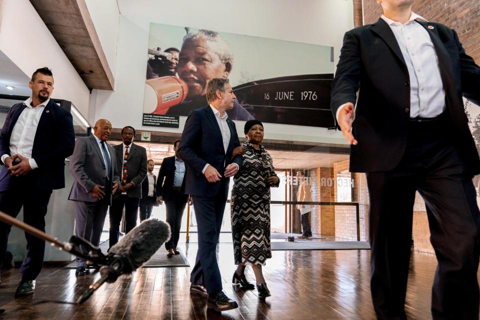 Secretary of State Antony Blinken and Antoinette Sithole, the sister of the late Hector Pieterson, tour the Hector Pieterson Memorial in Soweto, South Africa, Sunday, Aug. 7, 2022. Peaceful child protesters were gunned down by police 30 years ago in an attack that awakened the world to the brutality of the apartheid regime. At top, is an iconic picture of Antoinette, running with mouth open in a scream alongside a friend carrying the body of her slain brother, Hector. (AP Photo/Andrew Harnik, Pool)