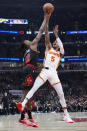 Chicago Bulls guard Ayo Dosunmu, left, blocks a shot by Atlanta Hawks guard Dejounte Murray during the first half of an NBA basketball play-in tournament game in Chicago, Wednesday, April 17, 2024. (AP Photo/Nam Y. Huh)