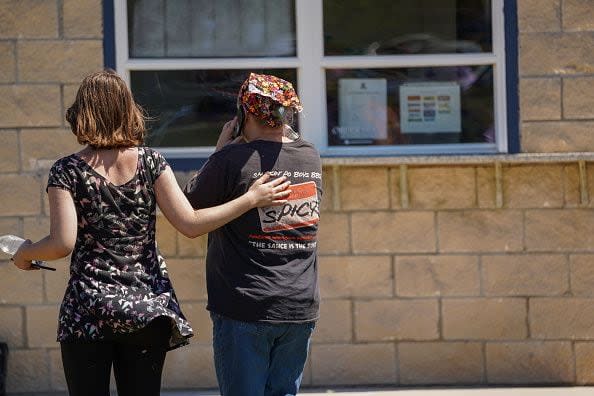 WINDER, GEORGIA - SEPTEMBER 4: A woman is comforted while on the phone after a shooting at Apalachee High School on September 4, 2024 in Winder, Georgia. Four fatalities and multiple injuries have been reported, and a 14-year-old suspect is in custody according to authorities. (Photo by Megan Varner/Getty Images)