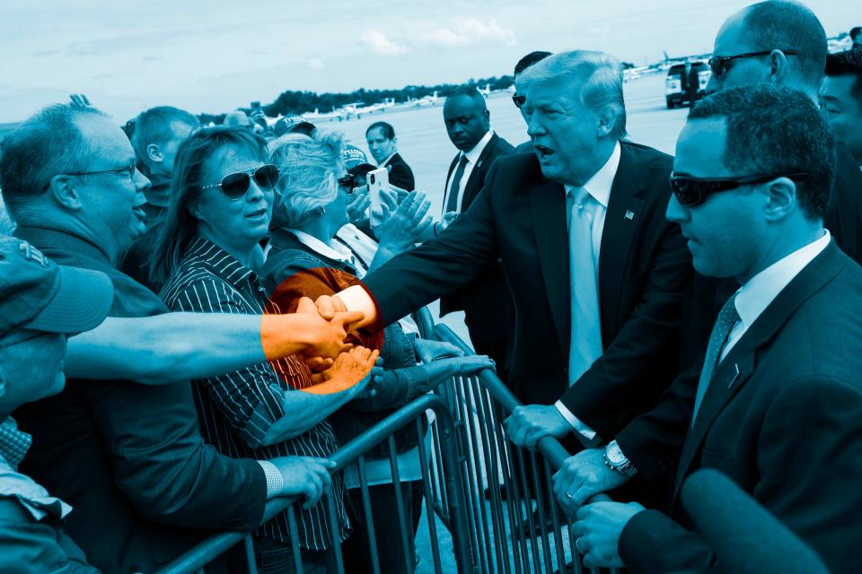 MARCH 9: President Donald Trump shakes hands with supporters upon arrival at the Orlando Sanford International Airport in Orlando, Fla.