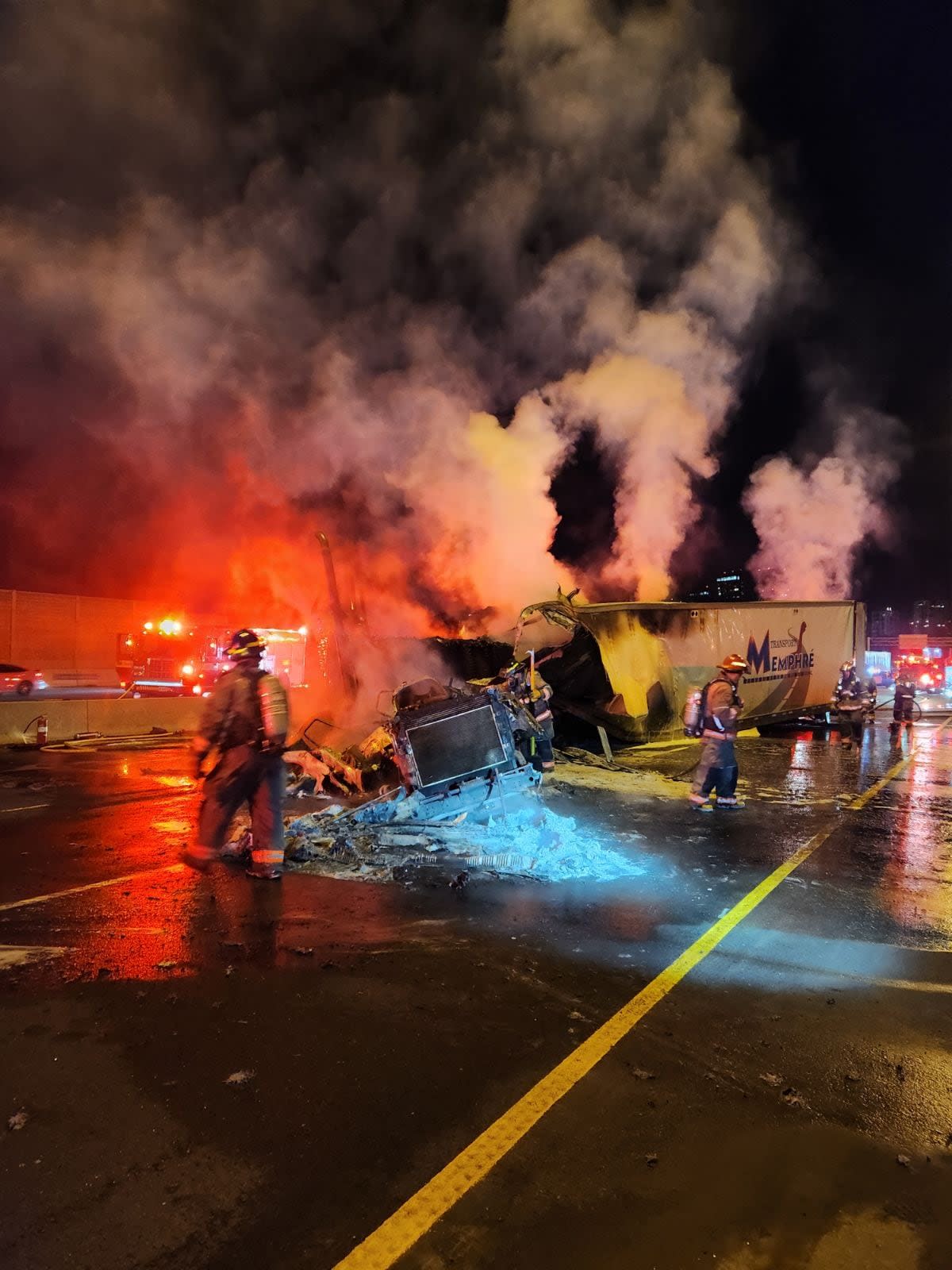 The driver of a transport truck loaded with cardboard collided with a guard rail on Highway 401 overnight, causing the truck to catch fire. (@OPP_HSD/Twitter - image credit)