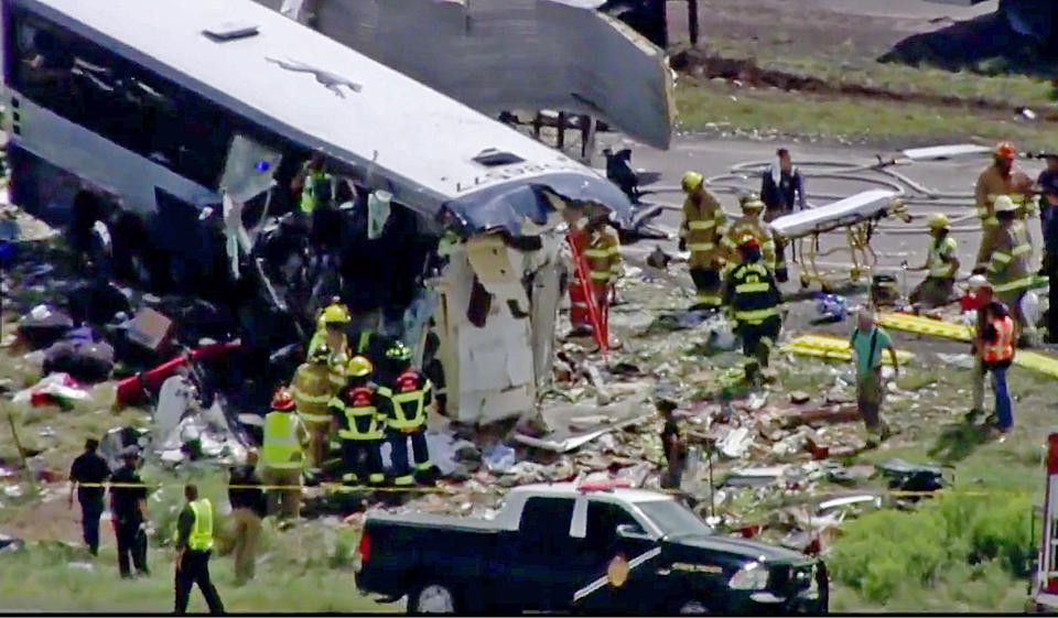 This photo from video provided by KQRENews13 shows first responders at the scene of the collision. Source: AP