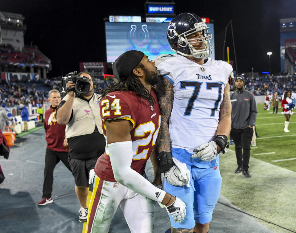 Cornerback Josh Norman and offensive tackle Taylor Lewan confront each other after Saturday’s game. (Getty Images)