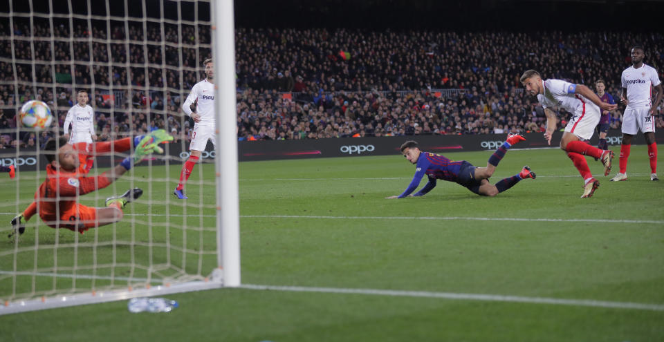 FC Barcelona's Coutinho, second left, heads the ball to score his side's third goal during a Spanish Copa del Rey soccer match between FC Barcelona and Sevilla at the Camp Nou stadium in Barcelona, Spain, Wednesday, Jan. 30, 2019. (AP Photo/Manu Fernandez)
