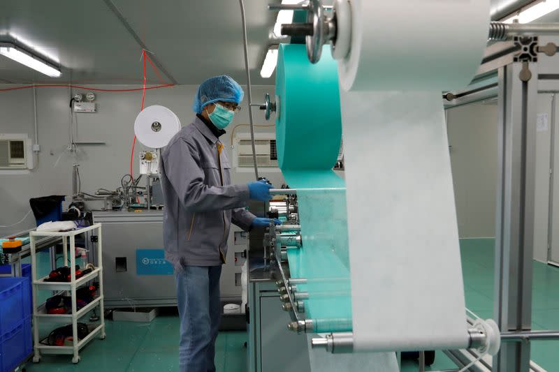 A man works on a production line for prototype face masks at Mask Factory, following the outbreak of the new coronavirus, in Hong Kong