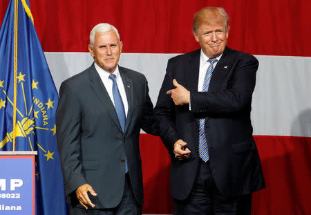 Republican presidential candidate Donald Trump (R) and Indiana Governor Mike Pence (L) wave to the crowd before addressing the crowd during a campaign stop at the Grand Park Events Center in Westfield, Indiana, July 12, 2016. REUTERS/John Sommers II