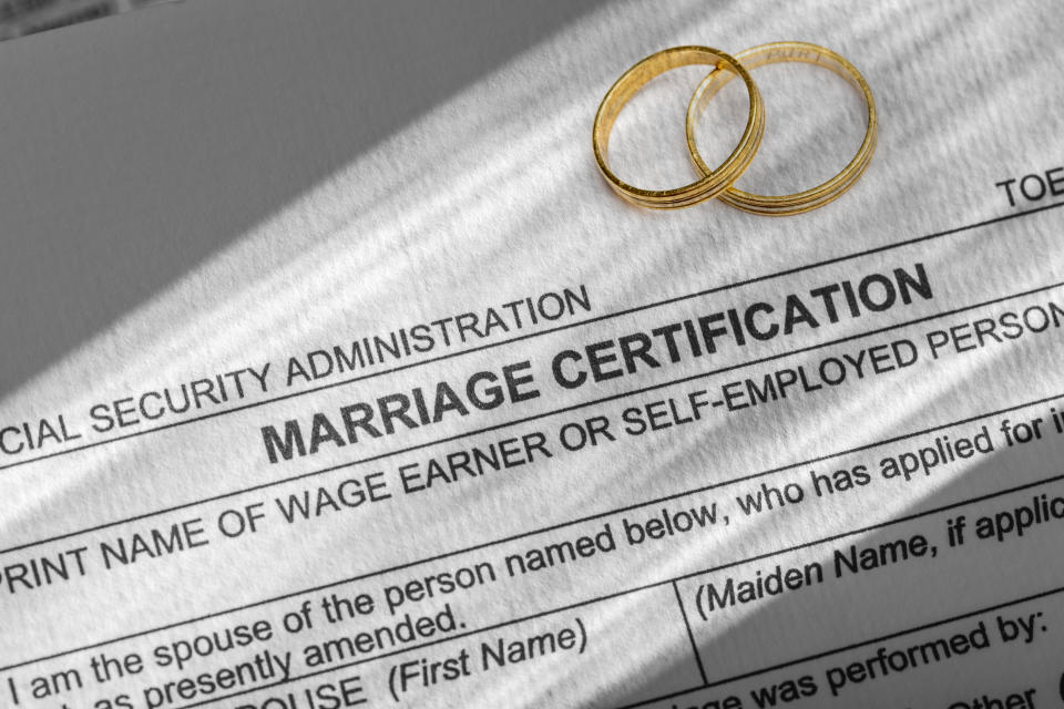 A marriage certificate and two wedding bands