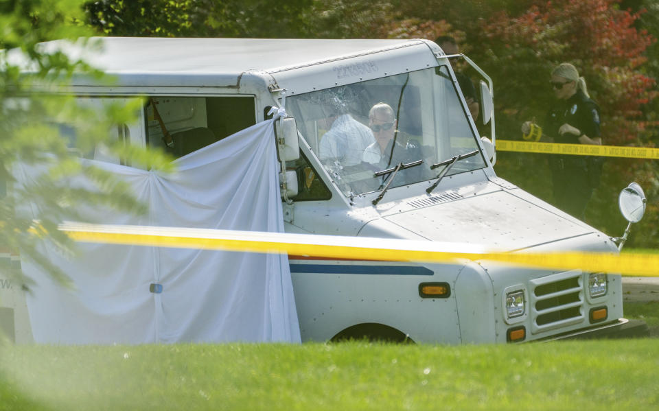 Police investigate the scene of a fatal shooting of a postal worker in front of a house on Suburban Ave. in Collier Township, Pa., outside of Pittsburgh, on Thursday, Oct. 7, 2021. (Andrew Rush/Pittsburgh Post-Gazette via AP)