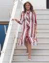 The First Lady landed at Kotoka International Airport in Accra wearing Manolo Blahnik court shoes and an old red and white striped dress by French fashion house Céline. [Photo: Getty]