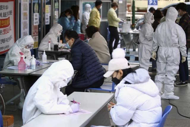 People suspected of being infected with the new coronavirus talk to medical centre workers to receive tests in Daegu, South Korea 