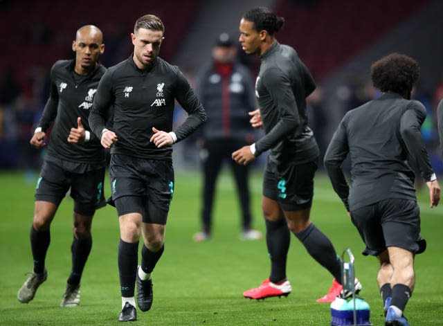 Fabinho, Jordan Henderson and Virgil van Dijk, left to second right, warm up with Liverpool