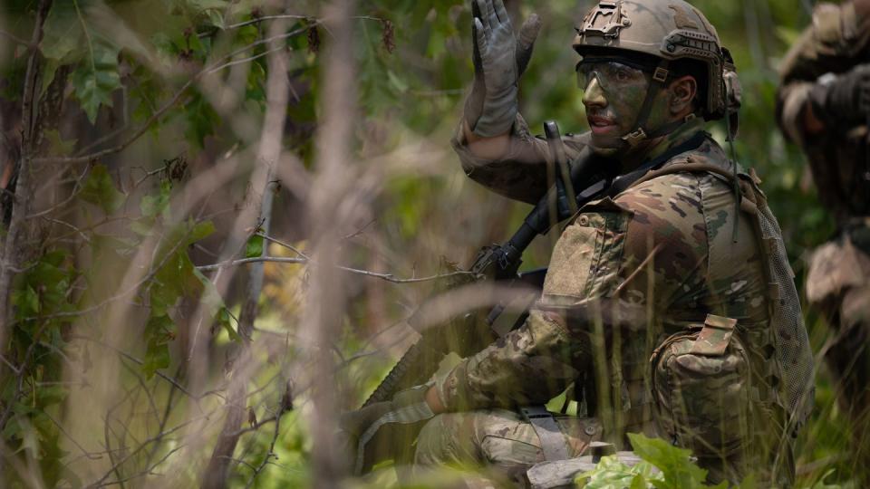 Combat controller and special tactics officer students plan a simulated ambush July 18 during Tactics Field Week in the North Carolina forests. he week prepares students within the Special Warfare Training Wing's 352nd Training Squadron for careers as combat controllers, special tactics officers and special reconnaissance airmen. (Miriam Thurber/Air Force)