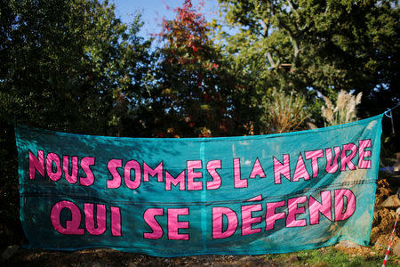 A banner which read : 'we are nature which defends" is displayed at "La Rolandiere" area in the zoned ZAD (Deferred Development Zone) in Notre-Dame-des-Landes, that is slated for the Grand Ouest Airport (AGO), western France, October 17,2016. Picture taken October 17, 2016. REUTERS/Stephane Mahe