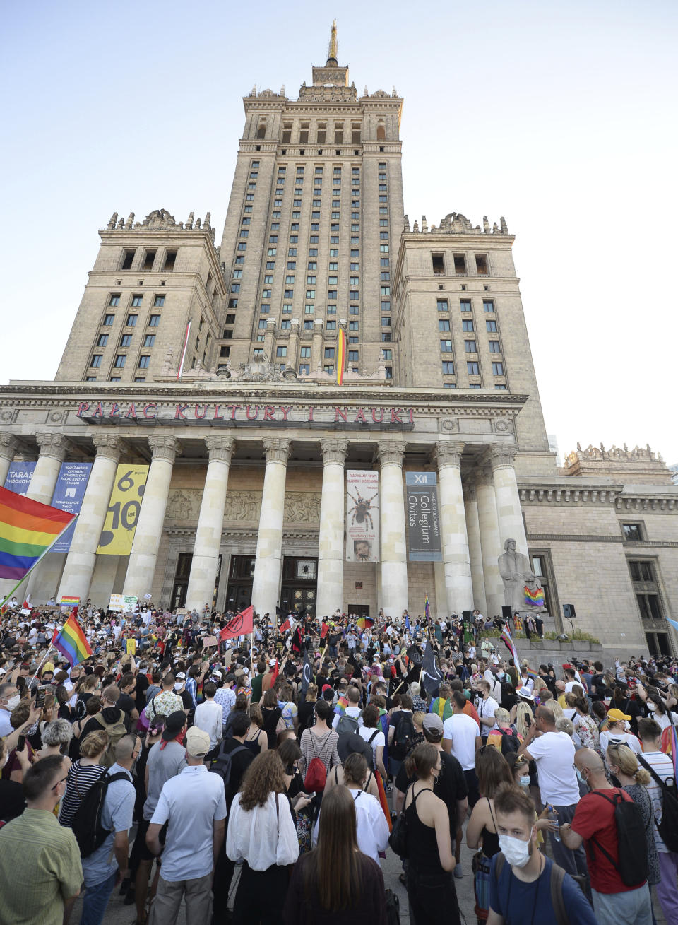 LGBT rights supporters protest in Warsaw, Poland, Saturday, Aug. 8, 2020. A large crowd of LGBT rights supporters gathered in Warsaw on Saturday to protest the arrest of a transgender activist who had carried out acts of civil disobedience against rising homophobia in Poland. (AP Photo/Czarek Sokolowski)