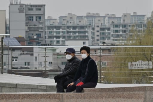 People wearing face masks take a rest at a park in Daegu, epicentre of the South Korean outbreak