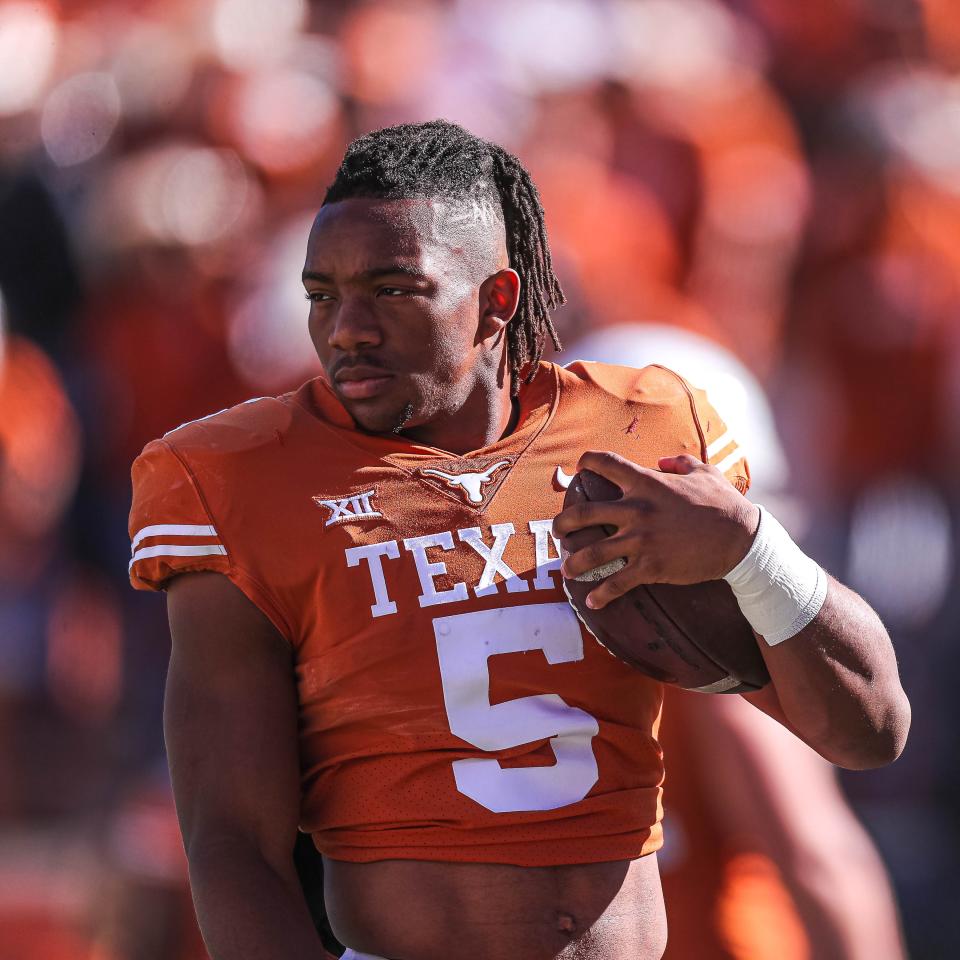 Texas running back Bijan Robinson (5) carries a ball during warmups before the Texas versus Oklahoma State football game at Darrell K. Royal Memorial Stadium on Saturday, Oct. 16, 2021.